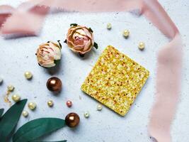 Handmade resin coaster with pearls and roses on a white background. photo