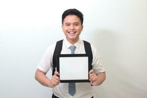 Indonesian senior high school student wearing white shirt uniform with gray tie showing empty frame. Blank space for typography or text to fill. Isolated image on white background photo