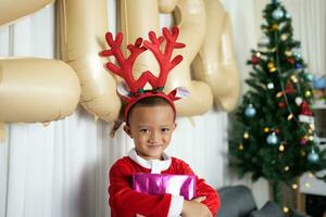 Merry Christmas 2024 concept Boy receives a gift from his mother at christmas photo