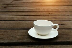 White coffee cup on wood floor. photo