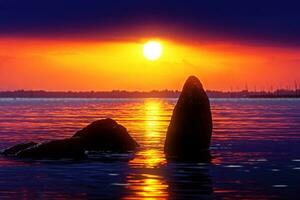 Sunset sky and stone at the lake in warm color. photo