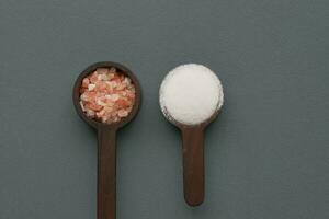comparing Raw dried pink Himalayan salt with white salt photo