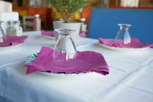 Empty plate, silverware and towel on table photo