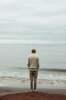 AI generated a man is standing at the beach near the ocean, photo