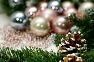 New Year's toys with fir branches and cones in blur, congratulatory background photo