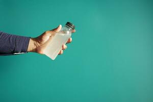 holding dirty bottle of water photo