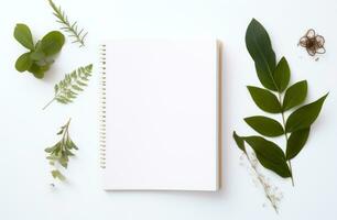 AI generated white background with empty notepad and green leaves around a white background photo