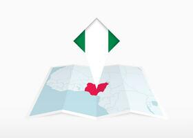 Nigeria is depicted on a folded paper map and pinned location marker with flag of Nigeria. vector