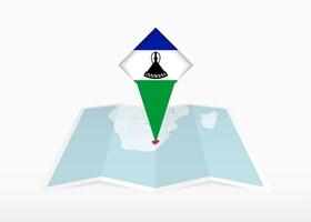 Lesotho is depicted on a folded paper map and pinned location marker with flag of Lesotho. vector