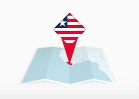 Liberia is depicted on a folded paper map and pinned location marker with flag of Liberia. vector