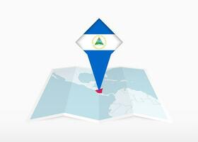 Nicaragua is depicted on a folded paper map and pinned location marker with flag of Nicaragua. vector