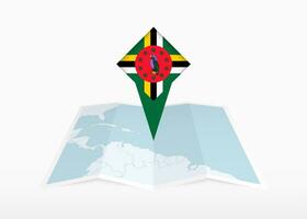 Dominica is depicted on a folded paper map and pinned location marker with flag of Dominica. vector