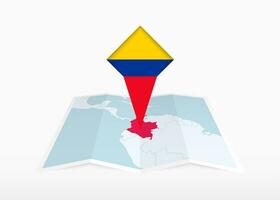 Colombia es representado en un doblada papel mapa y clavado ubicación marcador con bandera de Colombia. vector