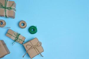 The box is packed in brown craft paper and tied with a rope on a blue background, gif photo