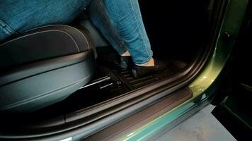 Travel by car. A closeup of the legs of a man getting into a car. A view of the feet getting into the car video