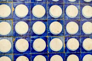 a blue and white tile wall with circles photo