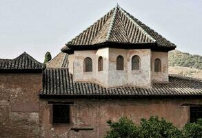 the roof of an old building with a tower photo