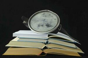 a used glasses and books on a black background photo