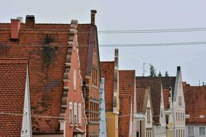 a row of houses with red roofs and windows photo