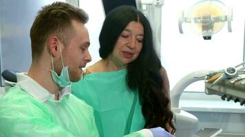 Woman looks at the dentist's tablet video