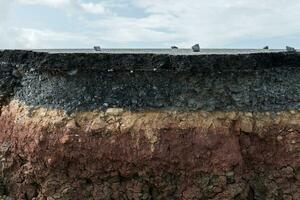 The layer of asphalt with soil and rock. photo