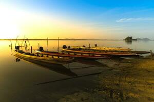 Local fishing boat morning light reflection. photo