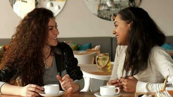 Two girls laugh at the cafe video