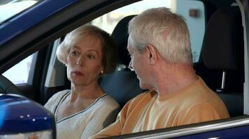 Senior couple talks inside the car video