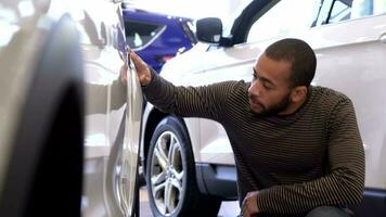 Man touches car wing at the dealership video