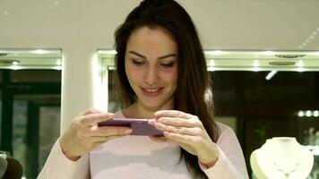 donna usi sua smartphone a il jewerly negozio video