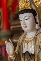 Close-up statue of Guan Yin, the Chinese goddess. photo