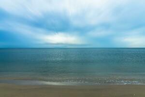 Quiet blue sea with motion cloud. photo