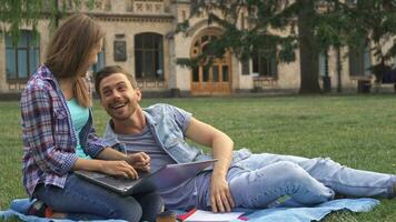 Couple of students exercises on the lawn on campus video