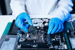 The technician is putting the CPU on the socket of the computer motherboard. electronic engineering electronic repair, electronics measuring and testing, repair photo