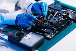 The technician is putting the CPU on the socket of the computer motherboard. electronic engineering electronic repair, electronics measuring and testing, repair photo