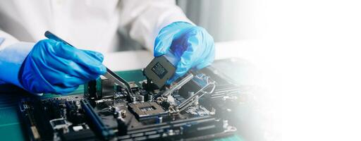 The technician repairing the motherboard in the lab with copy space. the concept of computer hardware, mobile phone, electronic, repairing, upgrade photo