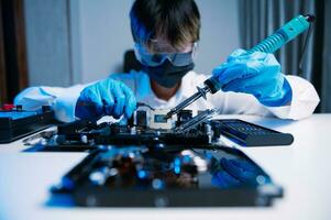The technician is putting the CPU on the socket of the computer motherboard. electronic engineering electronic repair, electronics measuring and testing, repair photo