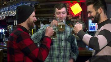 Friends clink their glasses at the pub video