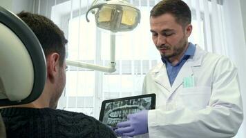 Dental specialist moves the image on the touchscreen video