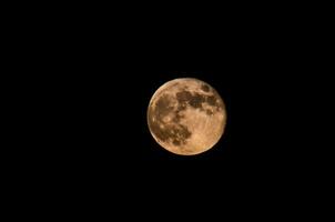 the full moon is seen in the dark sky photo