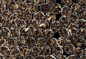 a close up of a pile of cigarettes photo