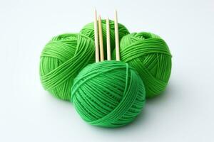 AI generated Balls of green yarn for knitting with knitting needles on a white background. Generated by artificial intelligence photo