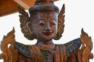 a wooden statue of a buddha with wings photo