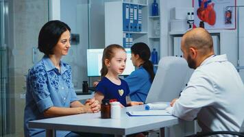 Doctor giving high five with little patient in medical office. Healthcare practitioner, physician, specialist in medicine providing health care services consultation diagnostic treatment in hospital. photo