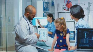 Doctor showing skeleton graphics on tablet during consultation. Healthcare practitioner physician specialist in medicine providing health care service radiographic treatment examination in hospital photo