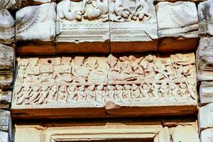 carvings on the wall of an ancient building photo