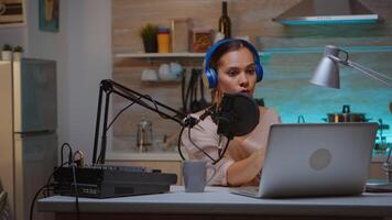Video blogger reading email and wearing headphones during broadcast. Creative online show Onair production internet broadcast host streaming live content, recording digital social media communication photo