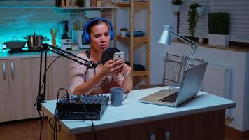 Speaking into professional microphone during podcast in home studio. Creative online show Onair production internet broadcast host streaming live content, recording digital social media communication photo