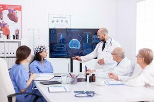Female nurse wearing scaning headset for brain activity during experiment and doctor telling diagnosis. Monitor shows modern brain study while team of scientist adjusts the device. photo