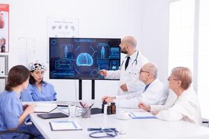 Medical nurse doing eeg scan during neuoroscience experiment and diagnosis. Monitor shows modern brain study while team of scientist adjusts the device. photo